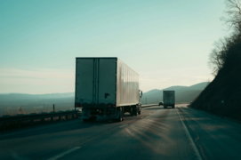 two-semi-trucks-driving-on-a-highway-.jpg Two semi-trucks driving on a highway.